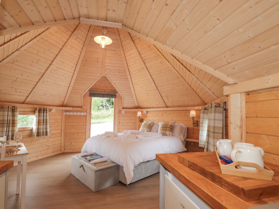 A bedroom with a bed and kitchenette at Little Luxe Lodges 2 Balmacara near Kyle of Lochalsh