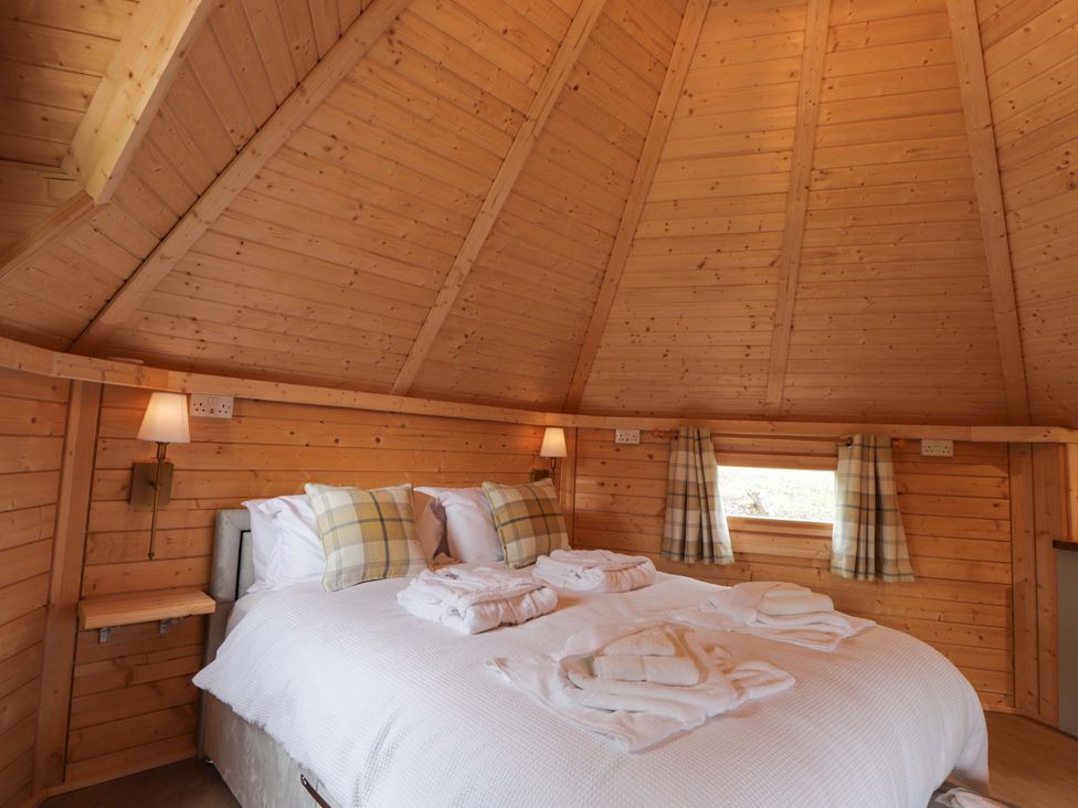 A bedroom with a double bed and wooden interior at Little Luxe Lodges 2 Balmacara near Kyle of Lochalsh