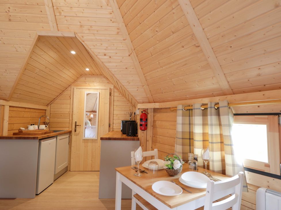 A kitchen with a table and chairs at Little Luxe Lodges 2 Balmacara near Kyle of Lochalsh