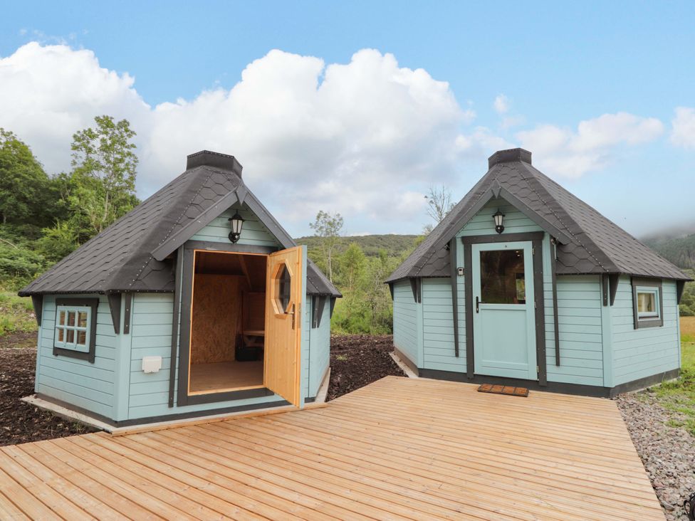 Two cabins with wooden decks and doors at Little Luxe Lodges 2 Balmacara near Kyle of Lochalsh