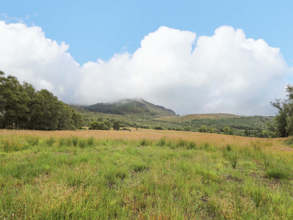 A scenic view of grassy fields and mountains at Little Luxe Lodges 2 Balmacara near Kyle of Lochalsh
