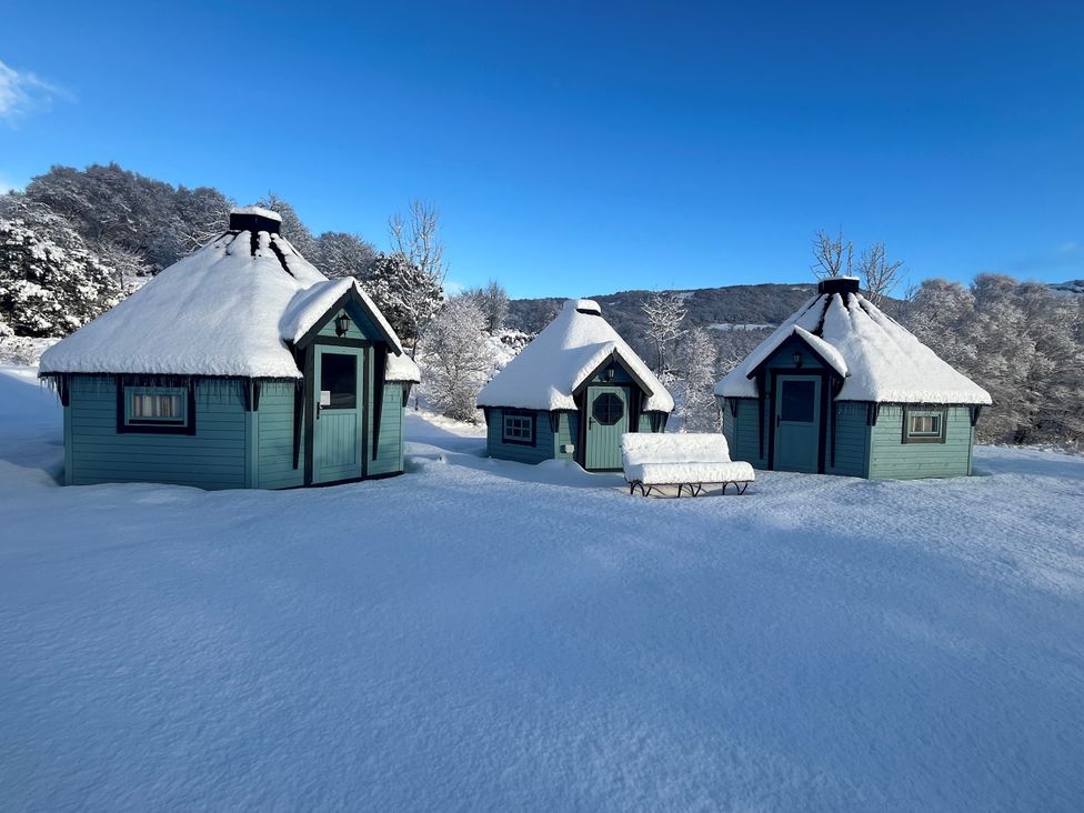 Three cabins in snow at Little Luxe Lodges 2 Balmacara near Kyle of Lochalsh