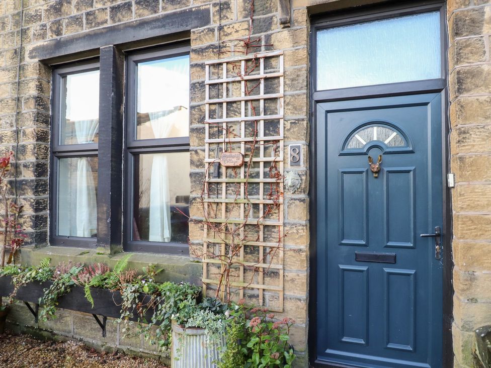 An entrance with a door and windows at Heathcliff Cottage