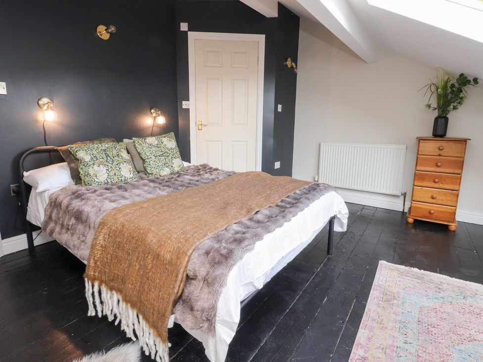 A bedroom with a bed and a chest of drawers at Heathcliff Cottage