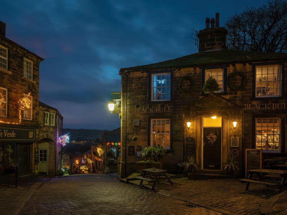 A streetscape featuring the Black Bull pub in Haworth