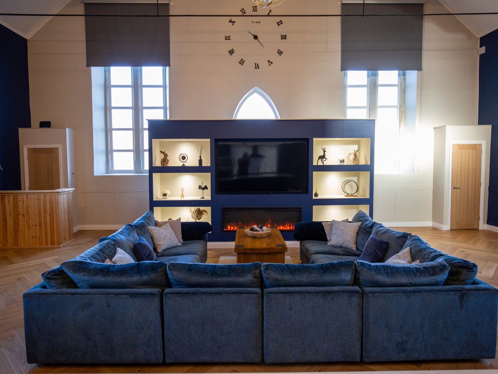 A living room with a large sofa and television at Moorsholm View Saltburn-by-the-Sea