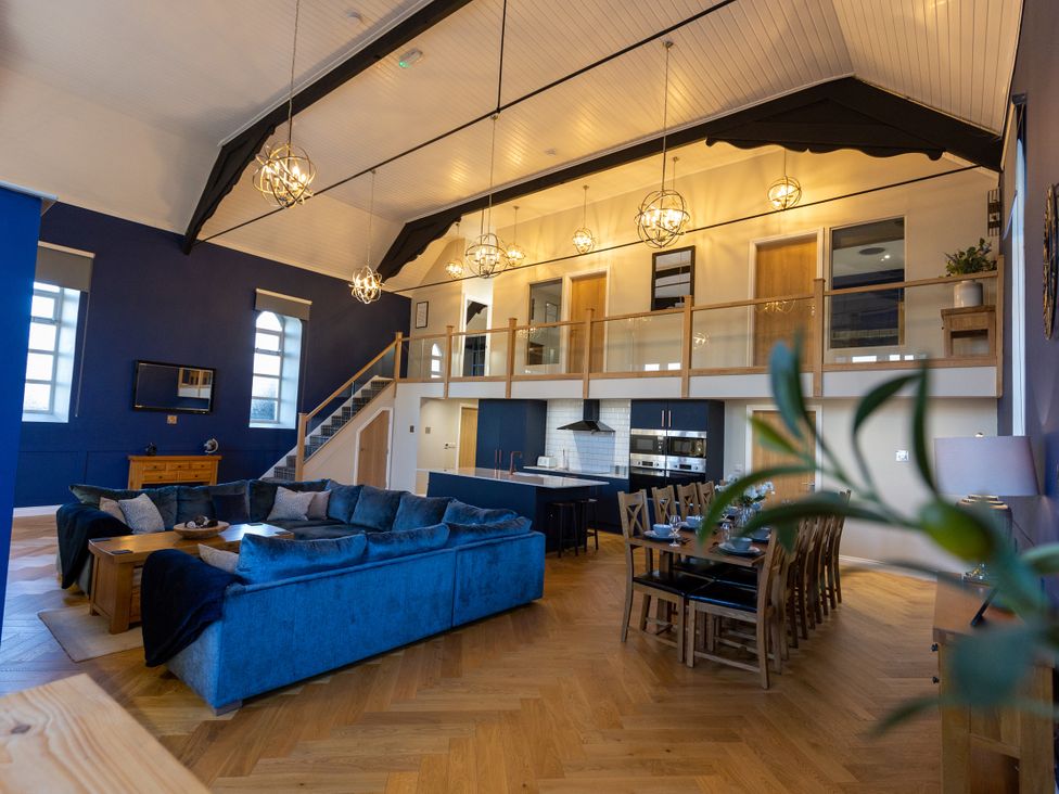 A living room with a sofa and dining table at Moorsholm View in Saltburn-by-the-Sea