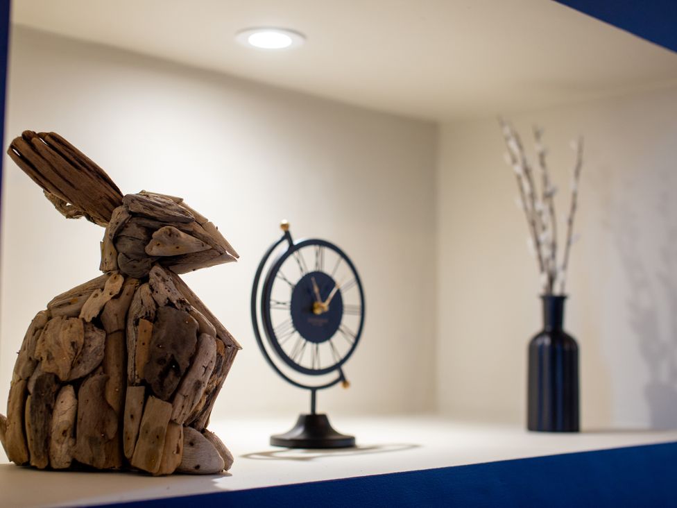 A decorative shelf with a rabbit sculpture and a clock at Moorsholm View in Saltburn-by-the-Sea