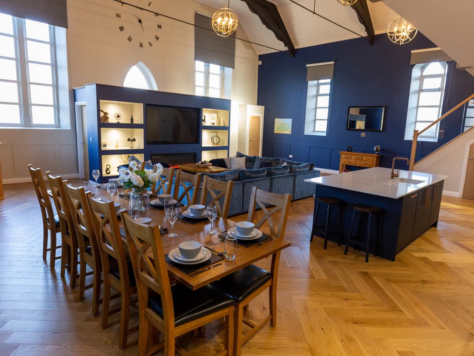 An open plan living room and dining area with a table set for dinner at Moorsholm View Saltburn-by-the-Sea