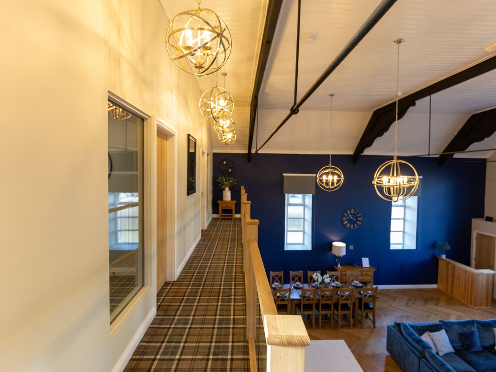 A hallway with light fixtures and doors at Moorsholm View in Saltburn-by-the-Sea