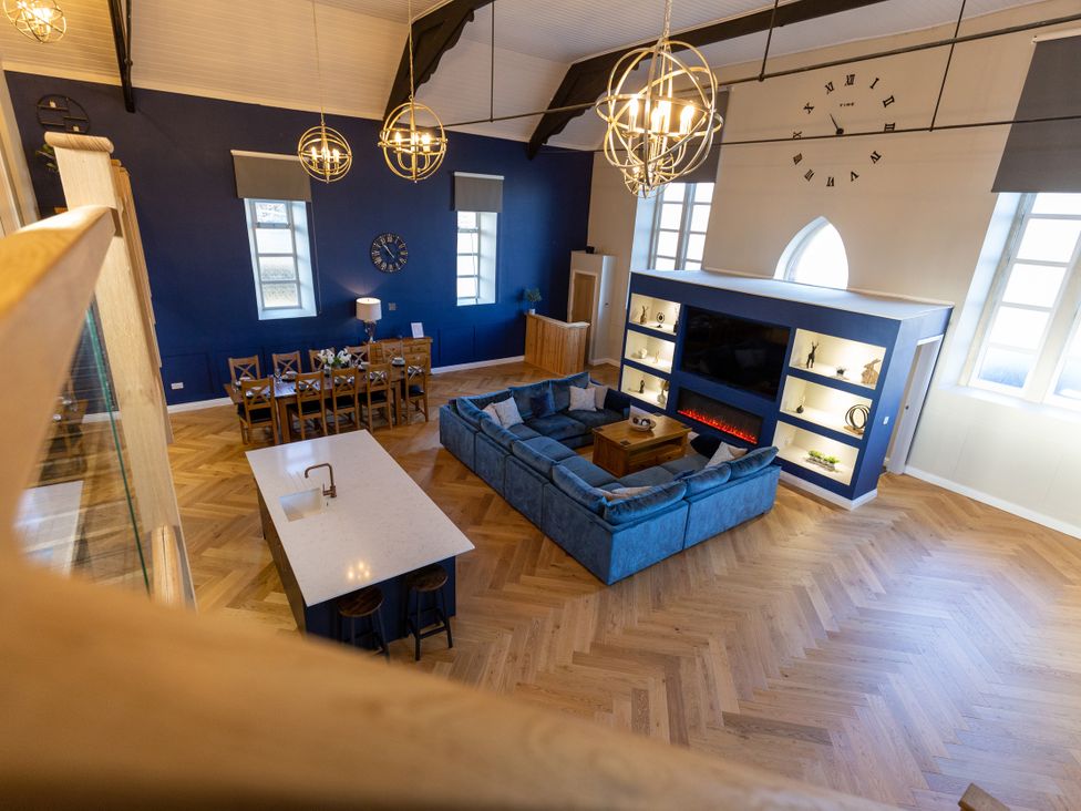 A living room with a sofa and dining area at Moorsholm View in Saltburn-by-the-Sea