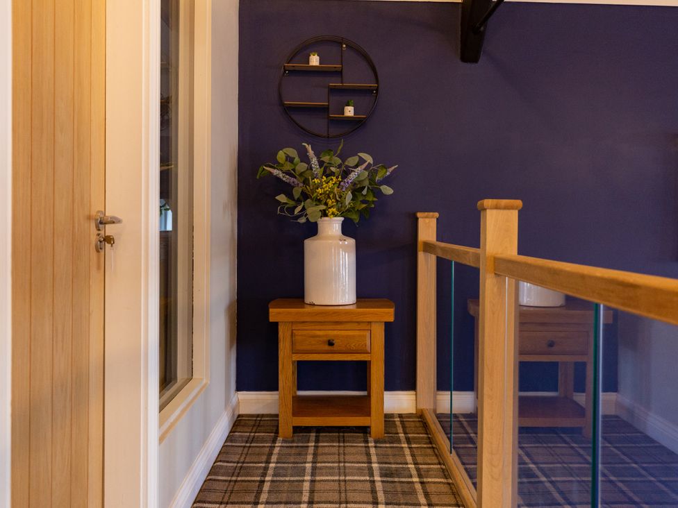 A hallway with a table and vase at Moorsholm View in Saltburn-by-the-Sea