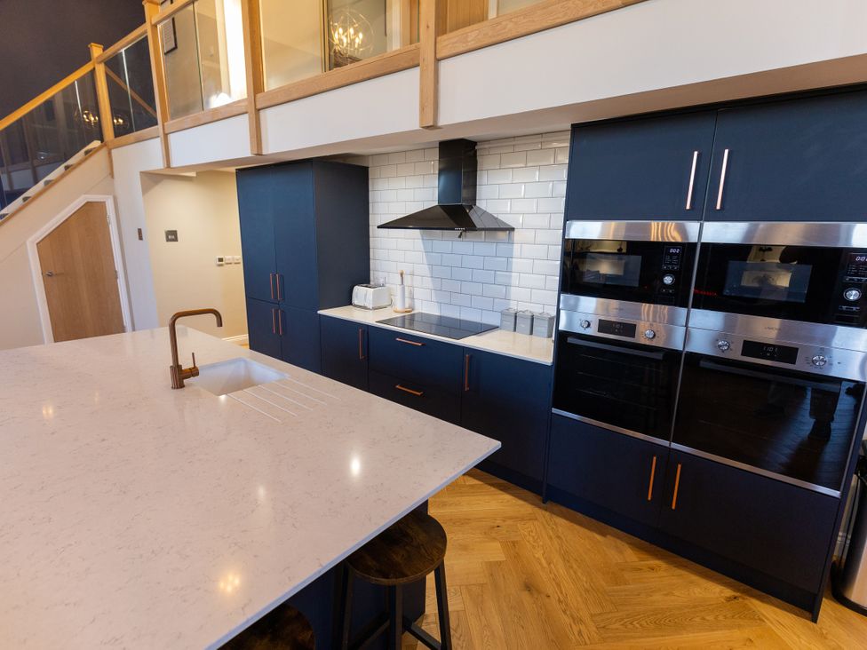 A kitchen with a countertop, sink, and ovens at Moorsholm View in Saltburn-by-the-Sea