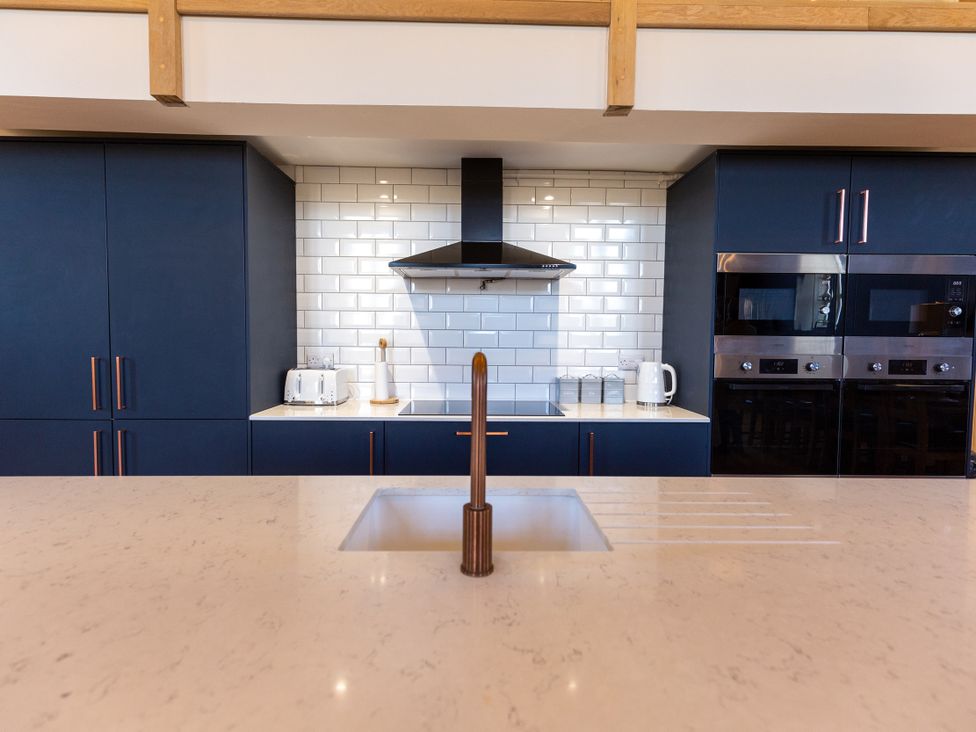 A kitchen with cabinets and appliances at Moorsholm View Saltburn-by-the-Sea