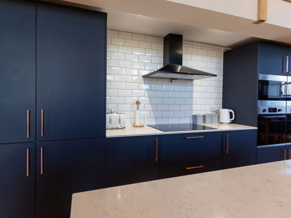 A kitchen with cabinets, kettle, and toaster at Moorsholm View in Saltburn-by-the-Sea