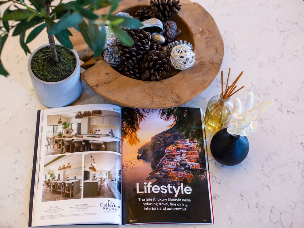 A magazine and decorative items on a table at Moorsholm View in Saltburn-by-the-Sea