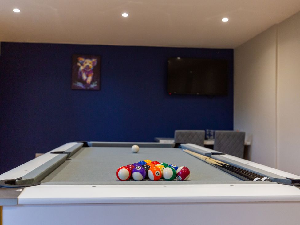 A pool table with balls and cue sticks in a game room at Moorsholm View Saltburn-by-the-Sea