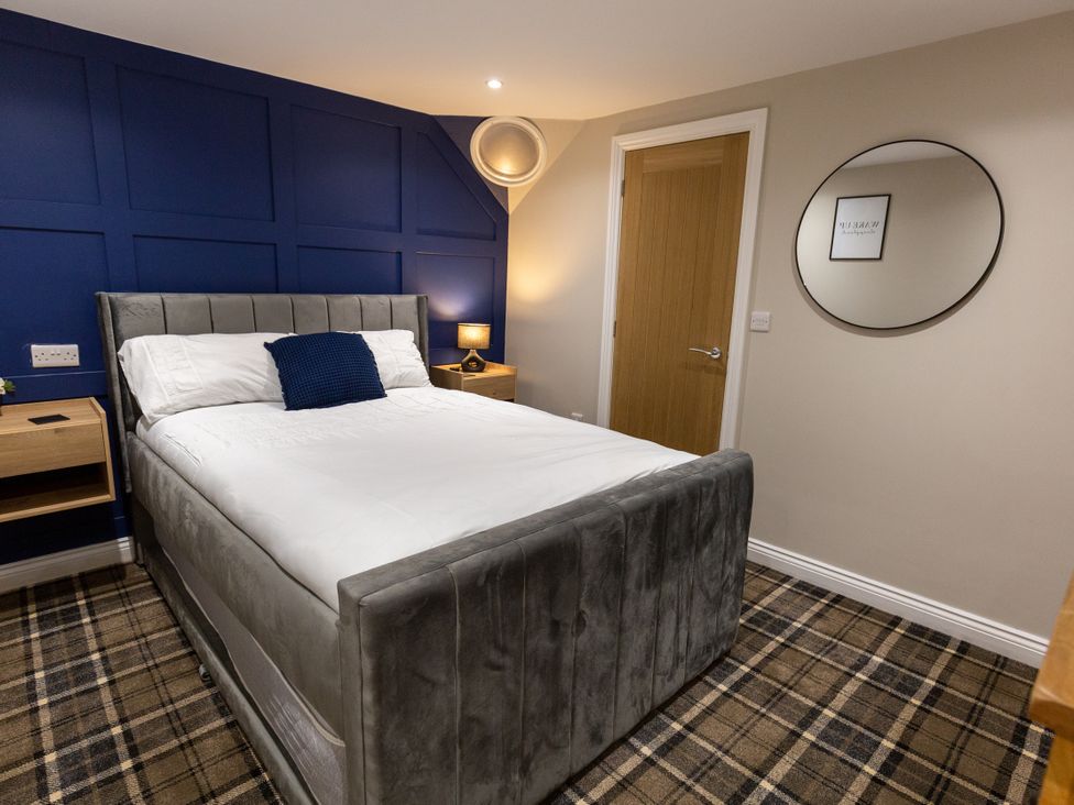 A bedroom with a bed and nightstand at Moorsholm View in Saltburn-by-the-Sea