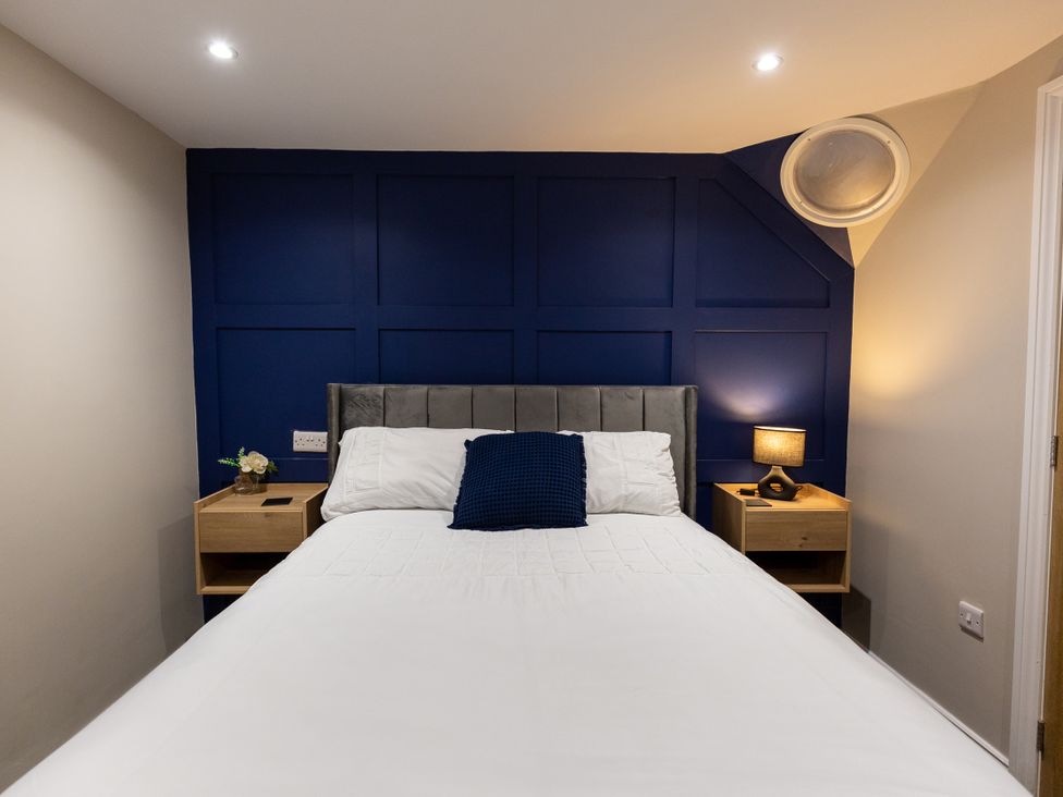 A bedroom with a bed and nightstands at Moorsholm View in Saltburn-by-the-Sea