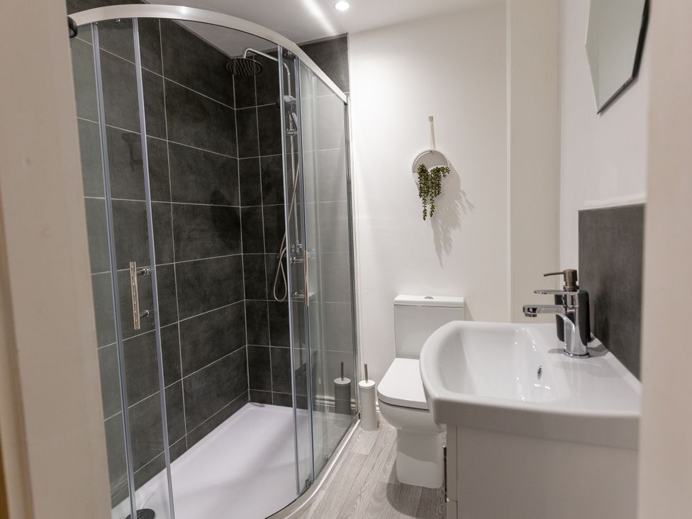 A bathroom with a shower, toilet and sink at Moorsholm View, Saltburn-by-the-Sea