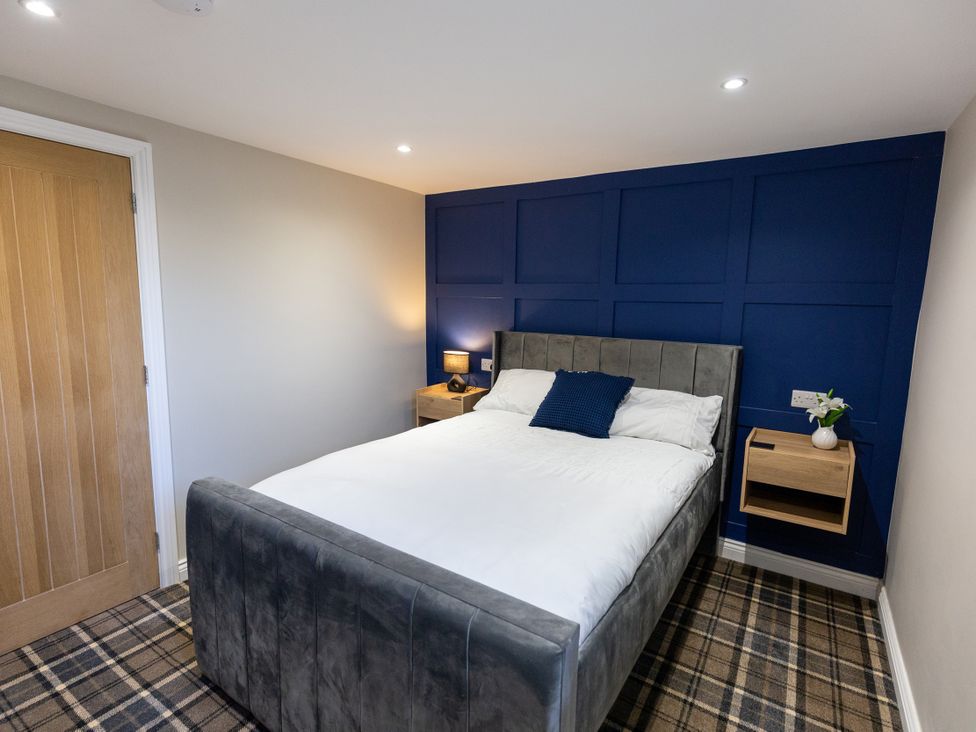 A bedroom with a bed and bedside table at Moorsholm View Saltburn-by-the-Sea