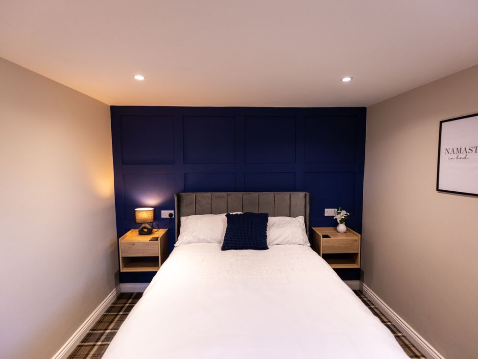 A bedroom with a bed and bedside tables at Moorsholm View in Saltburn-by-the-Sea