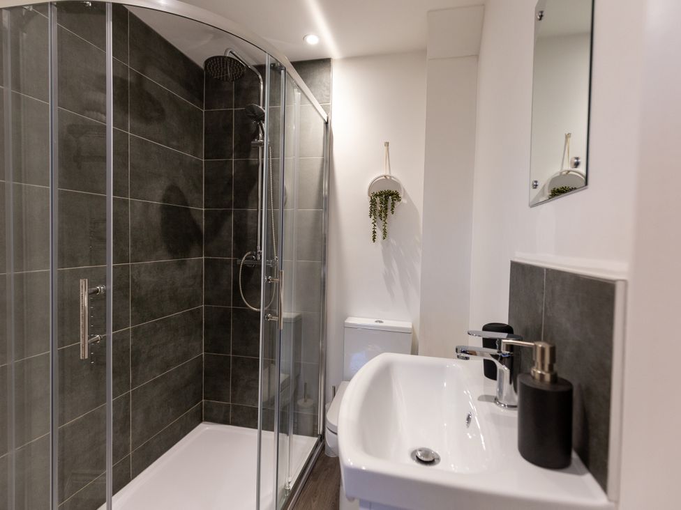 A bathroom featuring a shower, toilet, and sink at Moorsholm View in Saltburn-by-the-Sea