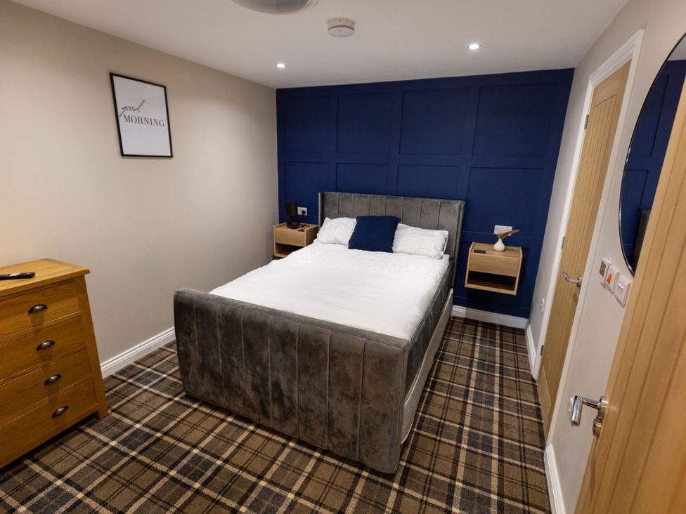 A bedroom with a bed and bedside table at Moorsholm View in Saltburn-by-the-Sea
