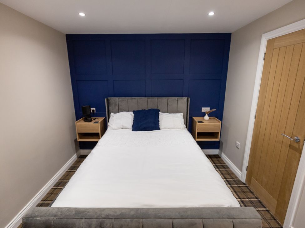 A bedroom with a bed and nightstands at Moorsholm View Saltburn-by-the-Sea