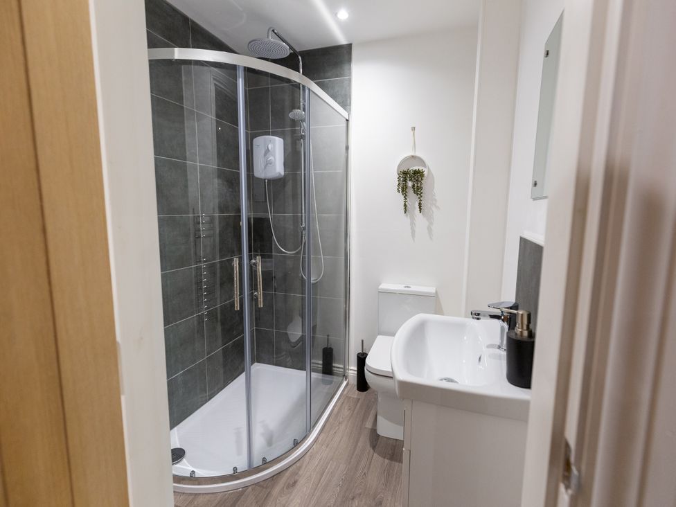 A bathroom with a shower, toilet, and sink at Moorsholm View in Saltburn-by-the-Sea