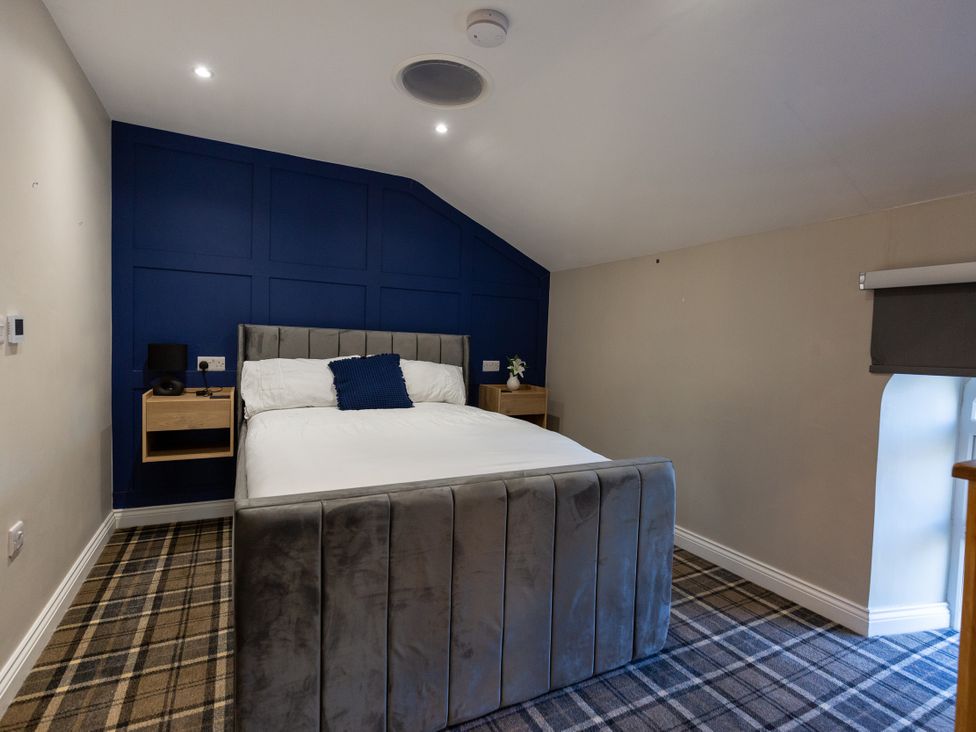 A bedroom with a bed and nightstand at Moorsholm View in Saltburn-by-the-Sea