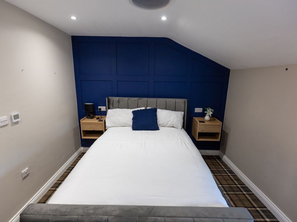 A bedroom with a bed and bedside tables at Moorsholm View in Saltburn-by-the-Sea