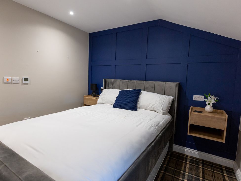 A bedroom with a bed and bedside table at Moorsholm View Saltburn-by-the-Sea