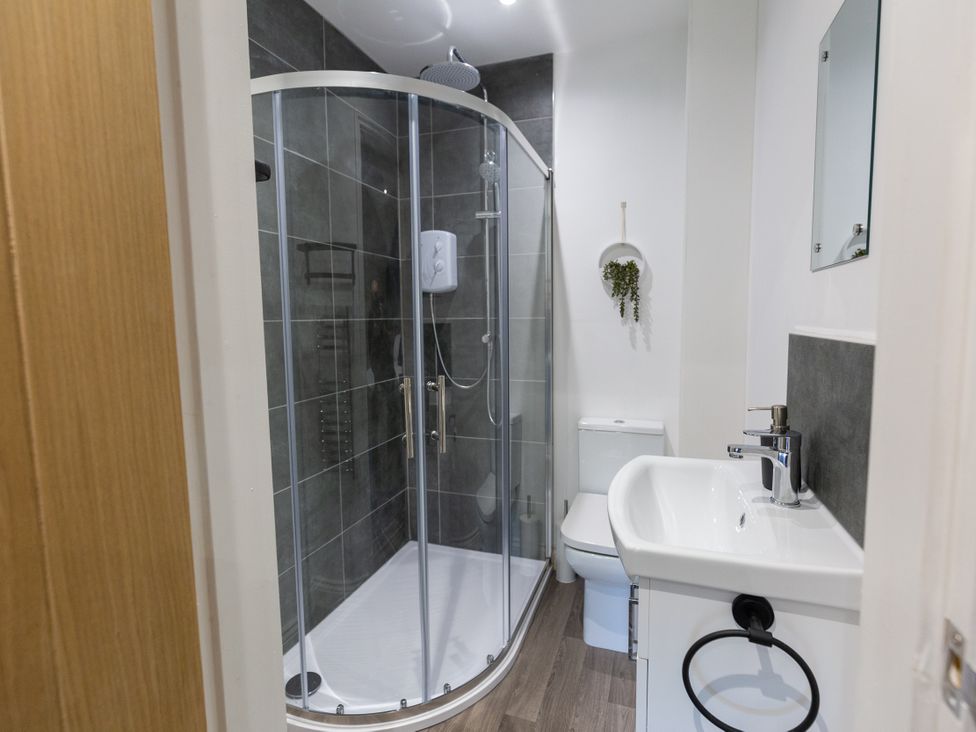 A bathroom with a shower, sink, and toilet at Moorsholm View Saltburn-by-the-Sea