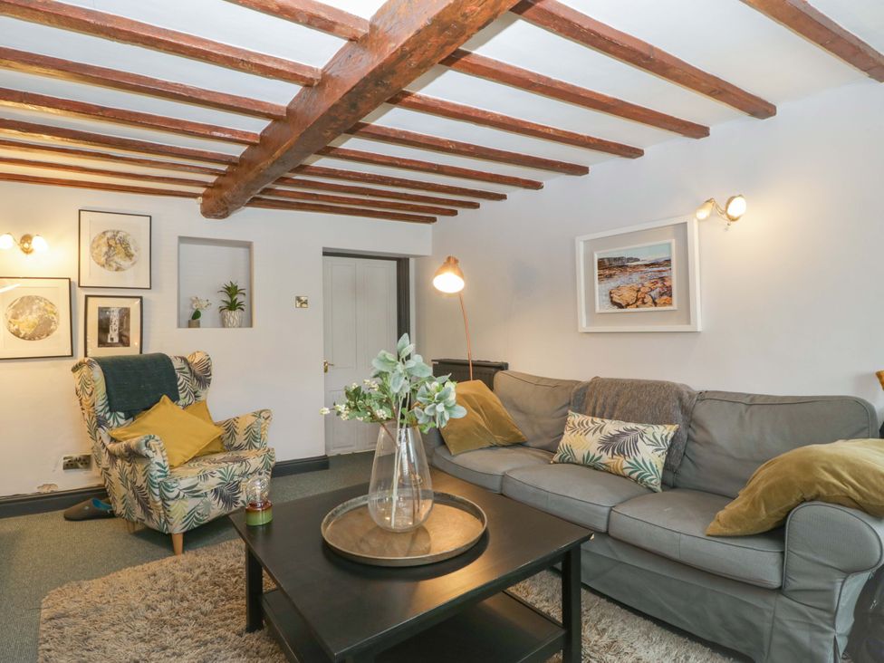 A living room with a sofa and armchair at Elm Cottage in Moreton-In-Marsh
