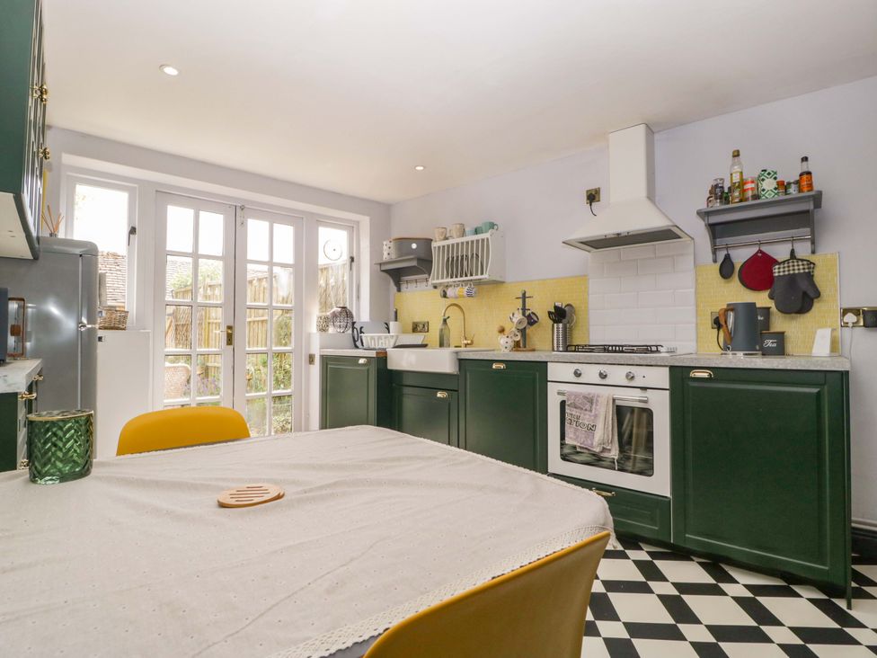 A kitchen with a table and chairs at Elm Cottage in Moreton-In-Marsh