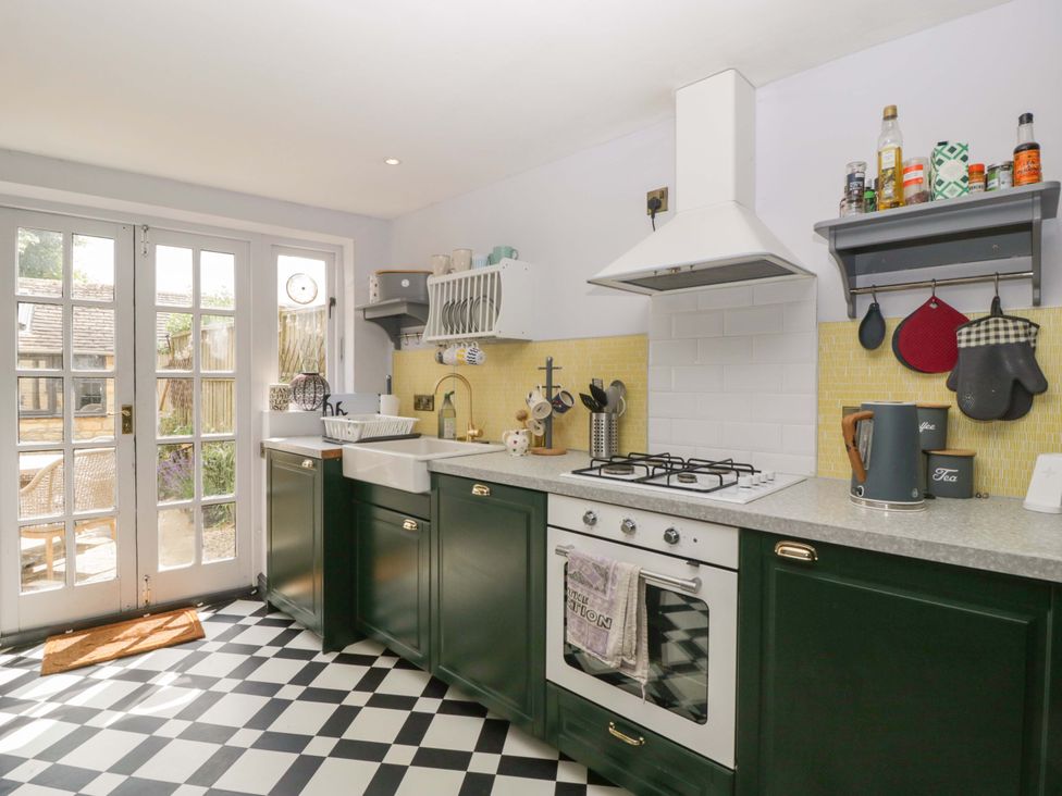 A kitchen with a sink and stove at Elm Cottage in Moreton-In-Marsh