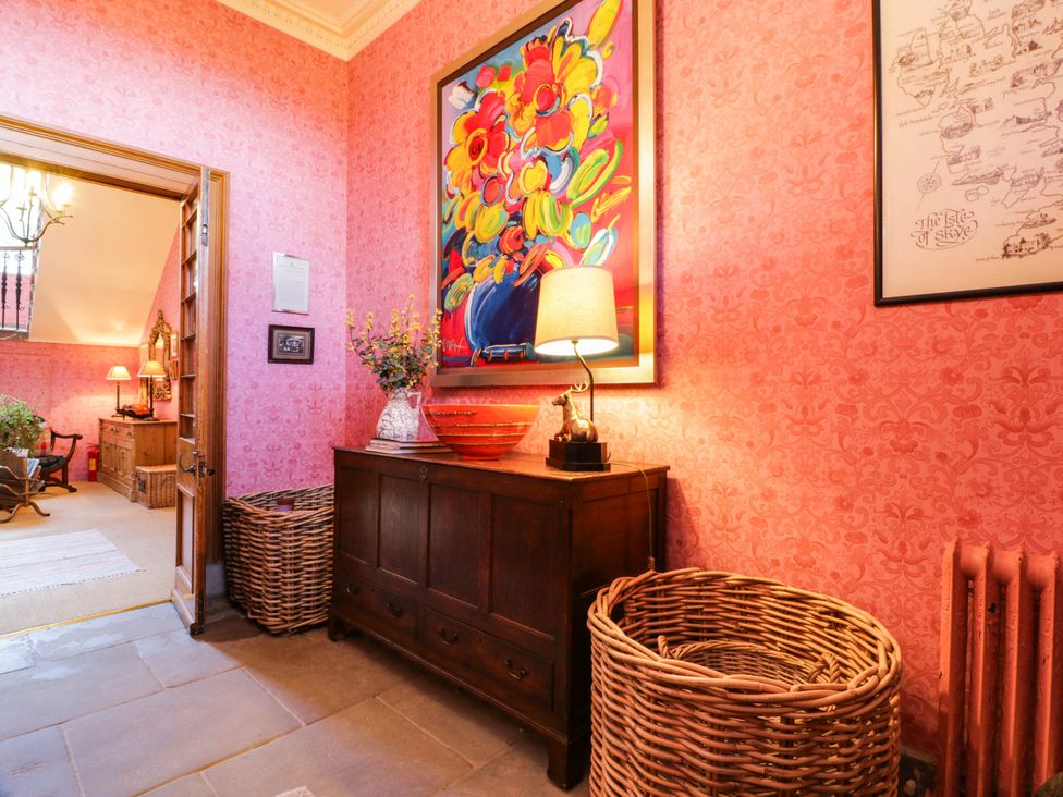 A hallway with a table lamp and a painting at Eagle Glen Manor House in Blairgowrie