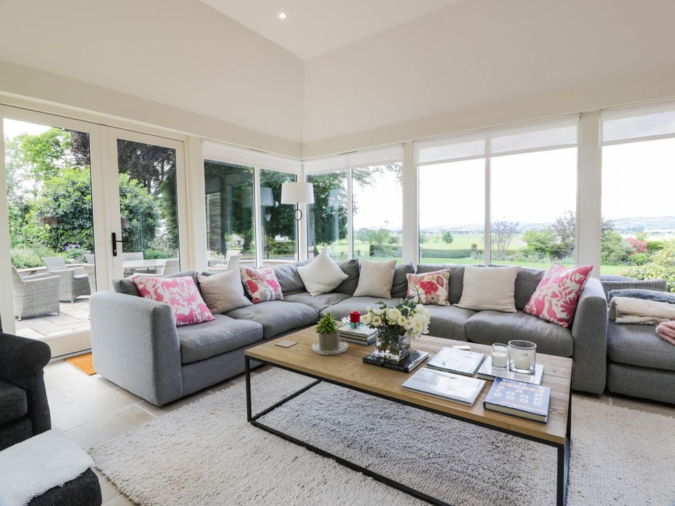 A living room with a sofa and coffee table at Eagle Glen Manor House in Blairgowrie