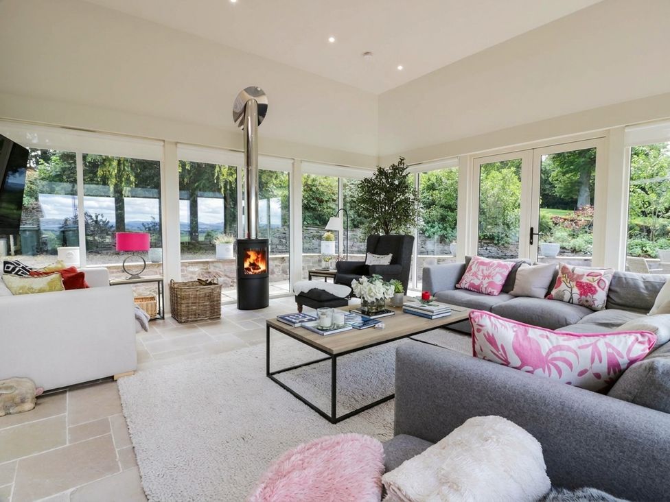 A living room with a fireplace and seating area at Eagle Glen Manor House in Blairgowrie