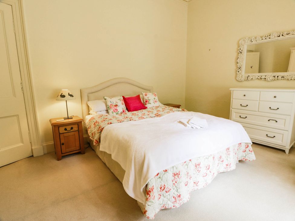 A bedroom with a bed and nightstand at Eagle Glen Manor House in Blairgowrie