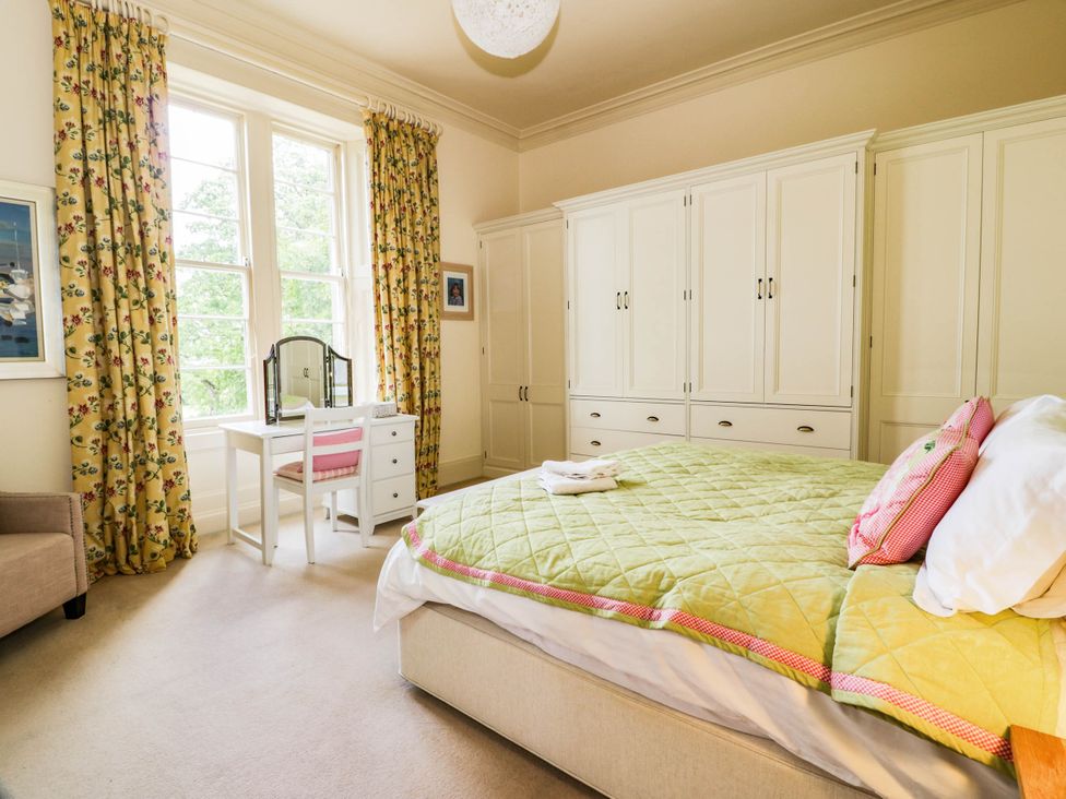 A bedroom with a bed and a desk at Eagle Glen Manor House in Blairgowrie