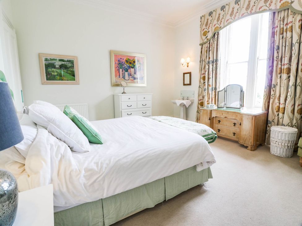 A bedroom with a bed and dresser at Eagle Glen Manor House in Blairgowrie