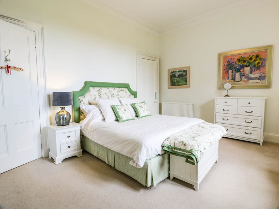 A bedroom with a bed and furniture at Eagle Glen Manor House in Blairgowrie