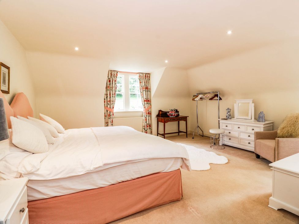 A bedroom with a bed and a dresser at Eagle Glen Manor House in Blairgowrie