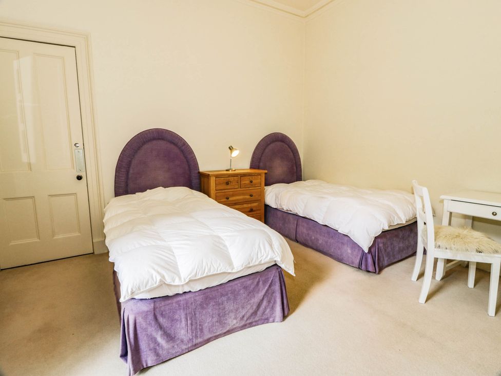 A bedroom with two beds and a dresser at Eagle Glen Manor House in Blairgowrie