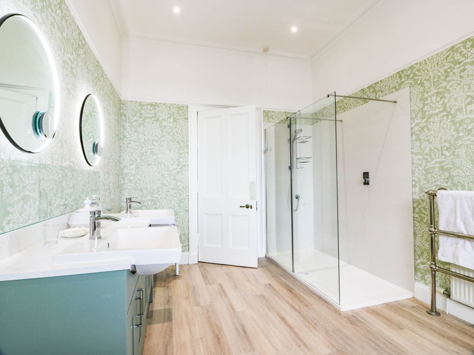 A bathroom with sinks and a glass shower at Eagle Glen Manor House in Blairgowrie