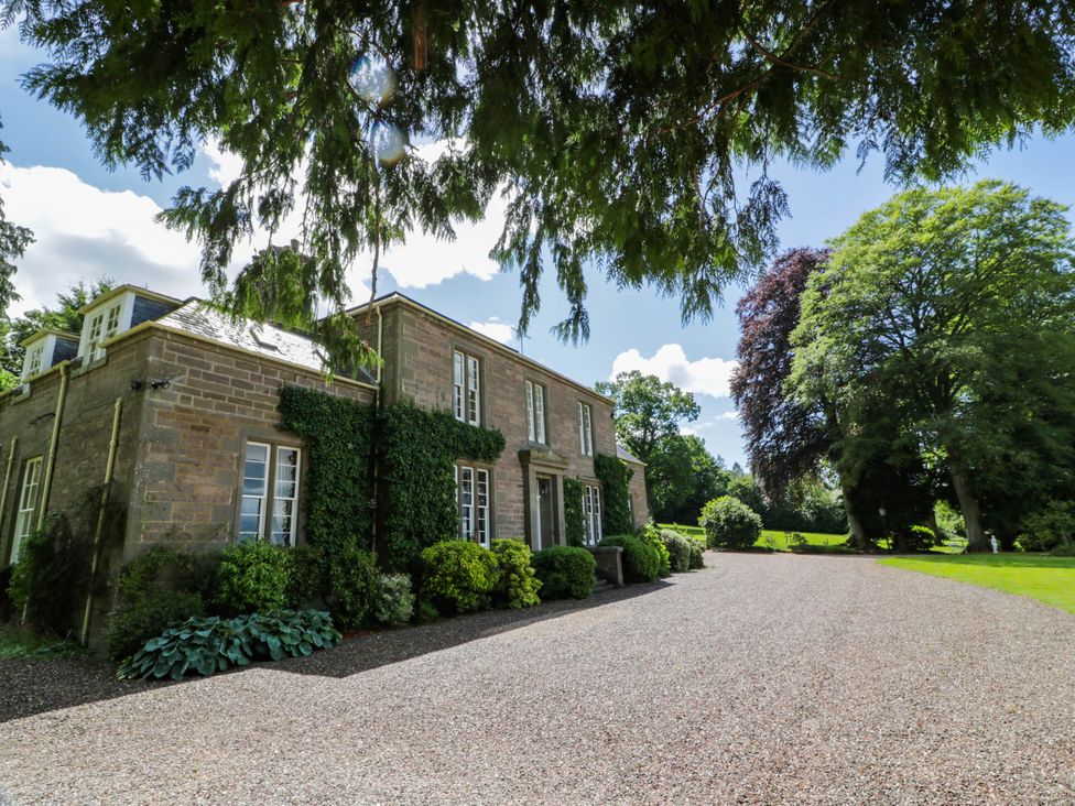 A house with a gravel driveway and garden at Eagle Glen Manor House in Blairgowrie