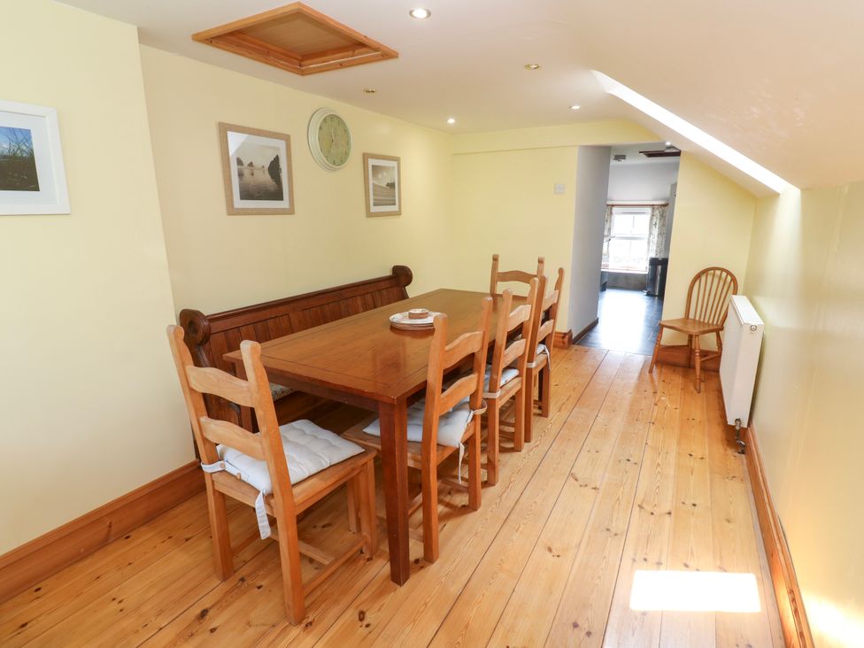 A dining room with a wooden table and chairs at The Cottage St. Ives
