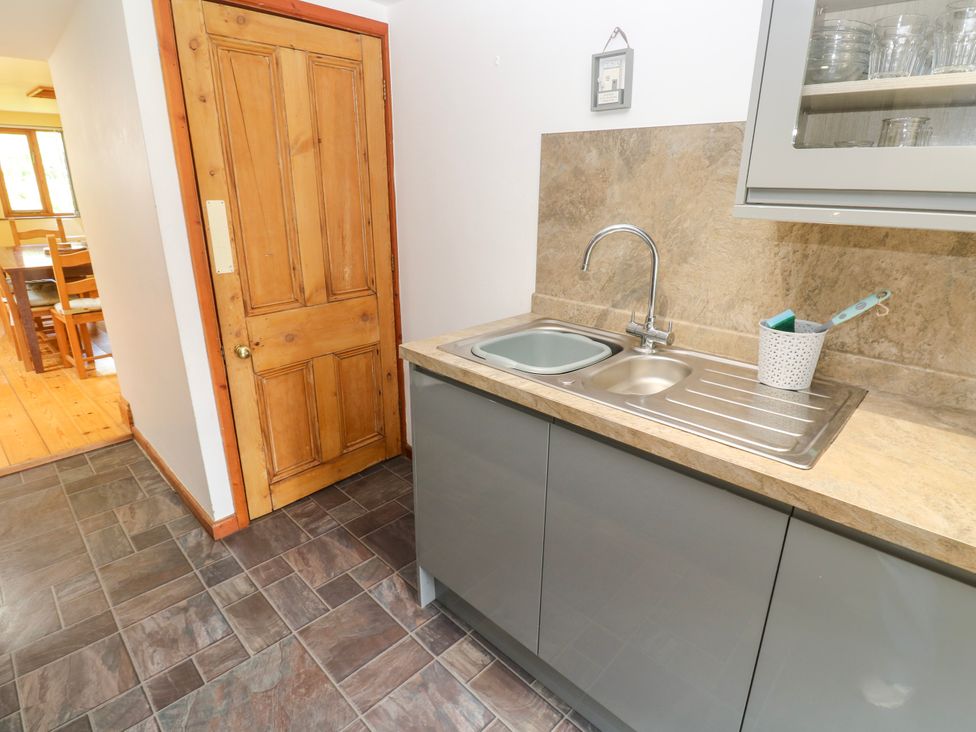 A kitchen with a sink and cupboard at The Cottage in St. Ives